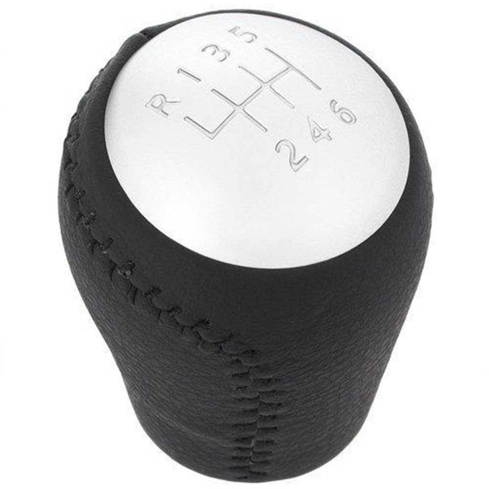 Fekete színű, bőrözött 6 sebességes Nissan váltógomb. Ezüst színű számlappal.