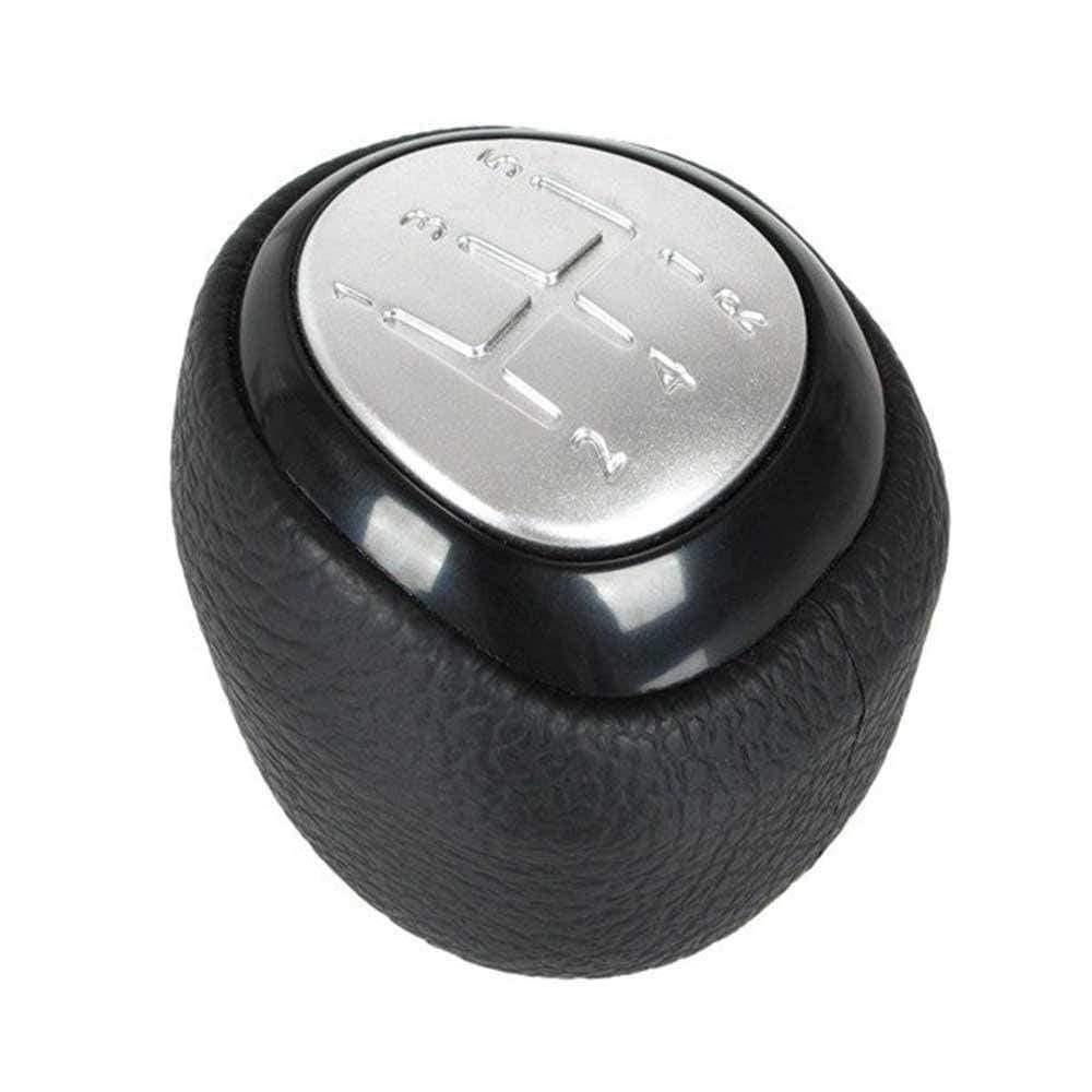 Fekete színű, 5 sebességes Saab váltógomb. Ezüst színű számlappal.