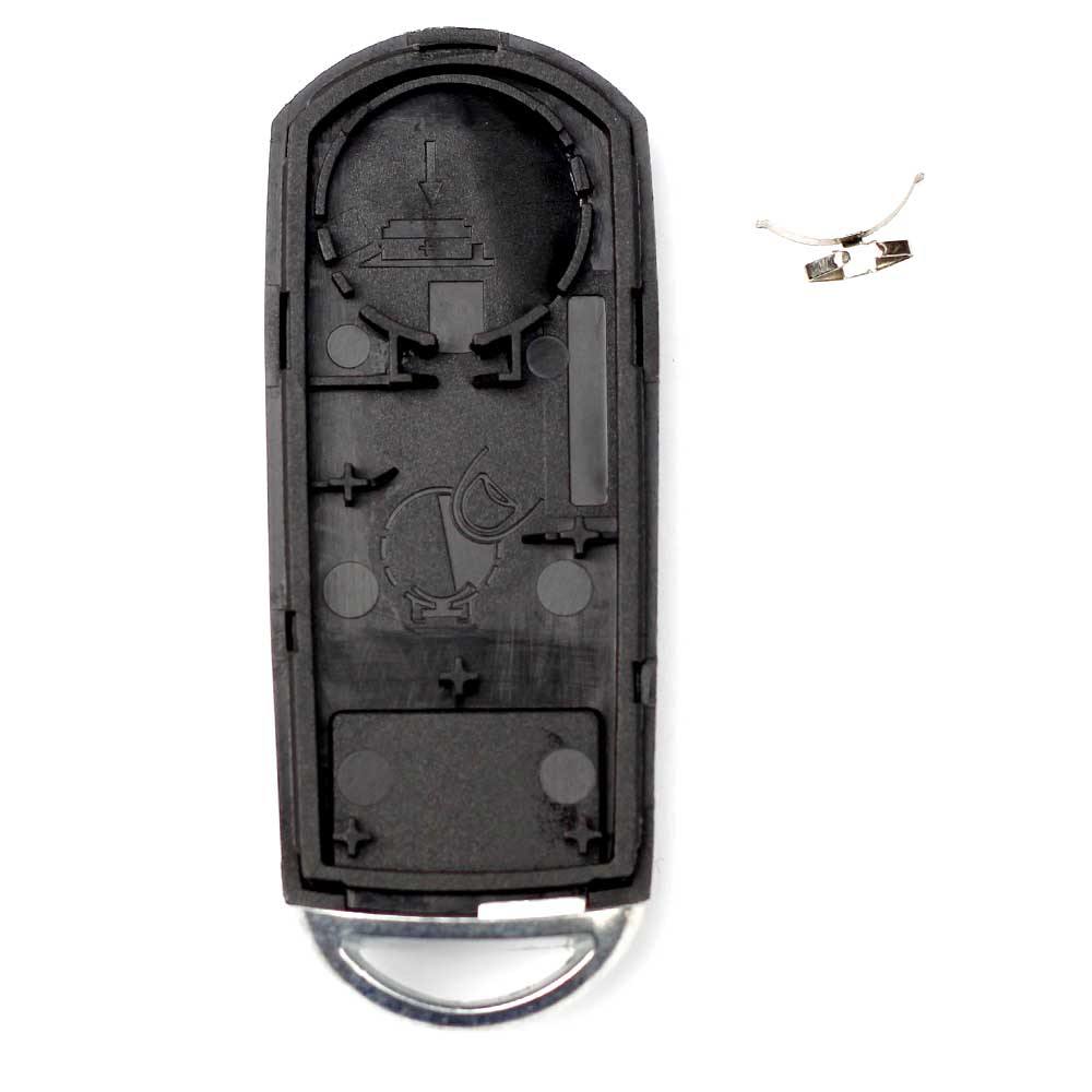 Fekete színű, 3 gombos Mazda kulcs, kulcsház belseje.